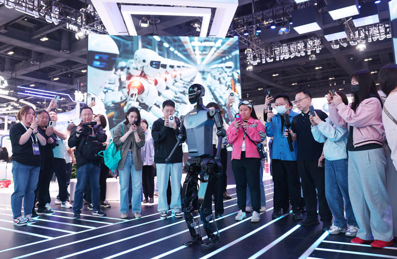 ▲在第二十七届中国北京国际科技产业博览会上,一款迈着稳健步伐绕场行走的机器人吸引了众多观众。新京报记者 李木易 摄